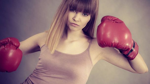 Woman wearing boxing gloves - Fotó, kép