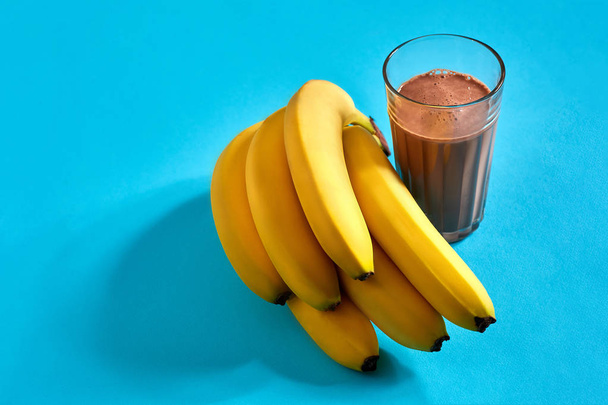 Banana smoothie with chocolate on blue background - Foto, imagen