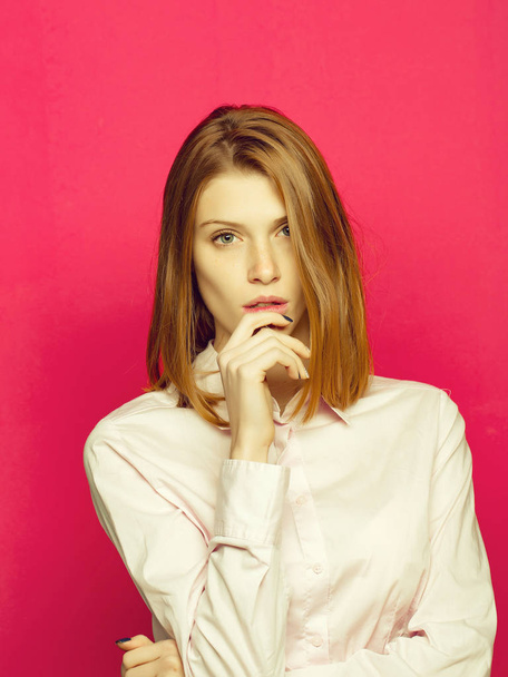 young pretty woman or fashionable sexy girl with cute face and short blonde hair in office shirt on pink background - Fotó, kép