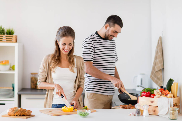 couple cooking food at home kitchen - Foto, Imagen