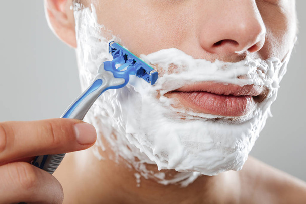 Close up portrait of a serious man with shaving foam - Foto, Imagem
