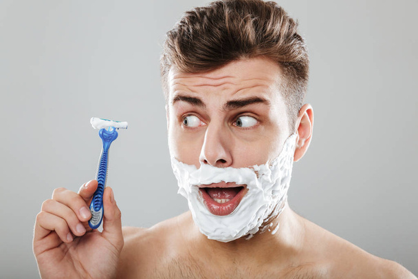 Close up portrait of a smiling man with shaving foam - Photo, image