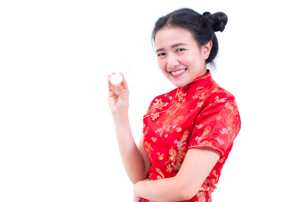 Beautiful Young asian woman wearing chinese dress traditional cheongsam or qipao with hand holding golden Bitcoin isolated on white background. Chinese New Year Festivities, Electronic money concept - Fotoğraf, Görsel