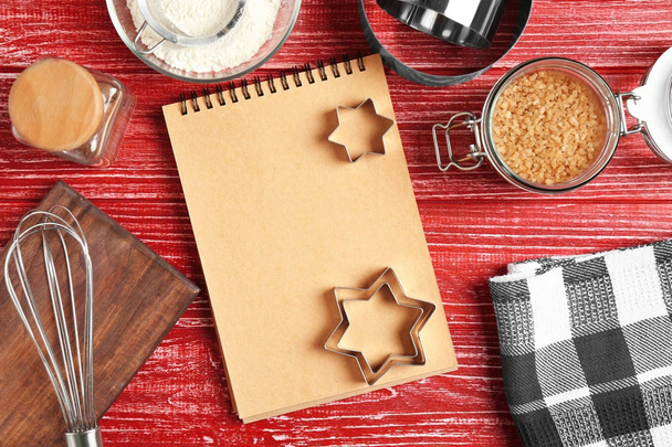 Kitchen utensils with ingredients for pastries and notebook on color wooden background - Φωτογραφία, εικόνα