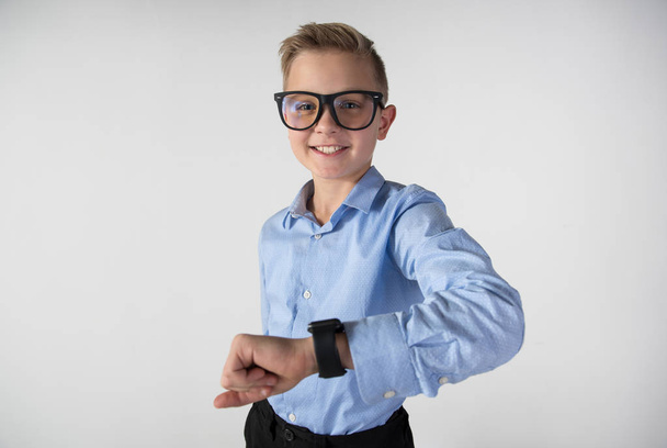 Glad kid in glasses looking at gadget - 写真・画像