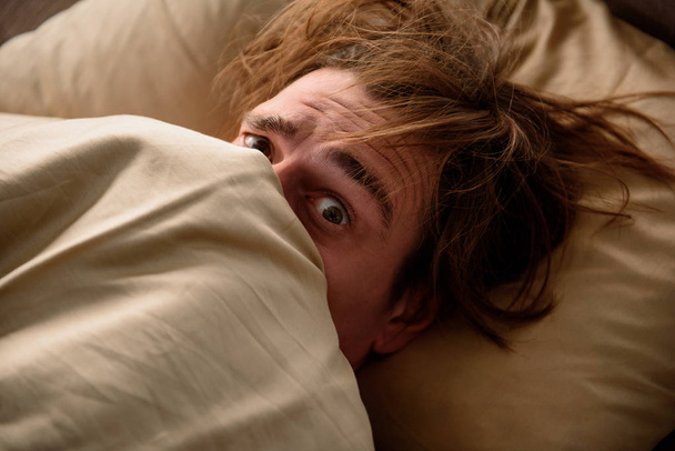 Scared guy unwilling to wake up at home - Foto, Imagem