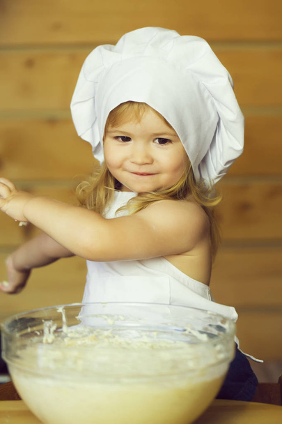 happy boy child cook kneading dough - Fotó, kép