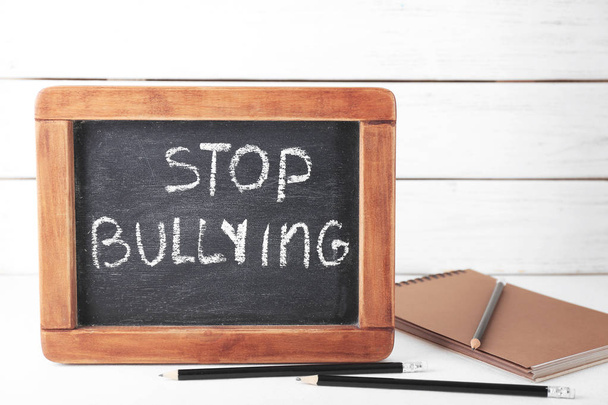 Chalkboard with text "Stop bullying" on table - Foto, immagini