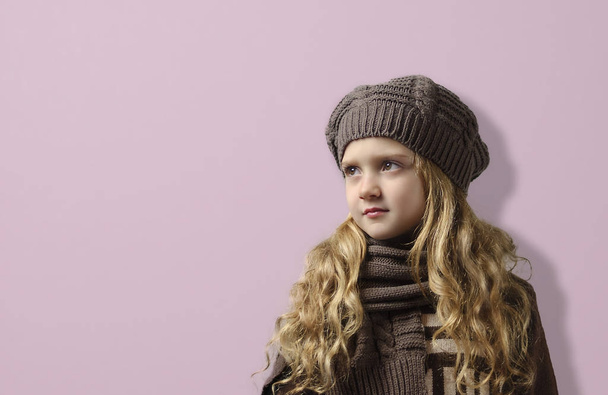 A girl in a knitted cap and scarf . - Photo, Image