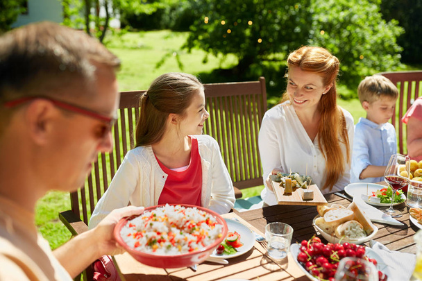 happy family having dinner or summer garden party - Zdjęcie, obraz