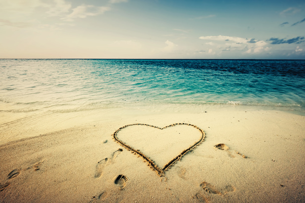 Heart shape drawn on a sand at the seaside. Love symbol. Tropical view. - Photo, Image
