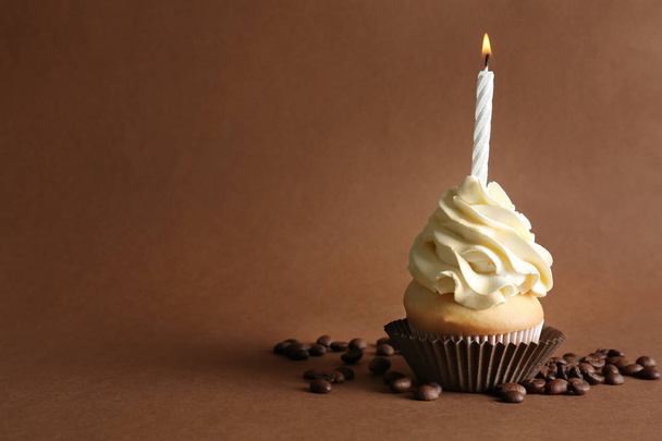 Birthday cupcake with candle on color background - Фото, изображение
