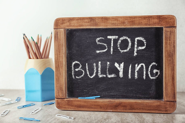 Chalkboard with text "Stop bullying" on table - Zdjęcie, obraz