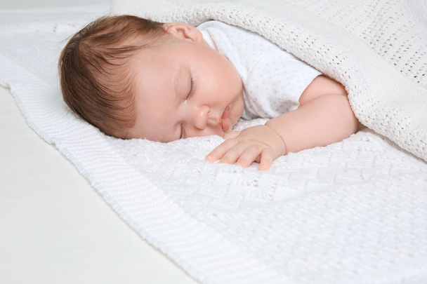 Cute little baby sleeping on plaid at home - Photo, image
