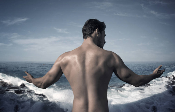 Handsome, muscular man posing on the seaside - Fotografie, Obrázek