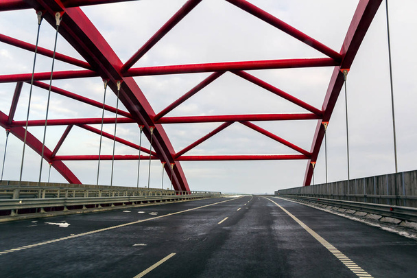 Metal frame structure of a bridge over a highway road - Zdjęcie, obraz