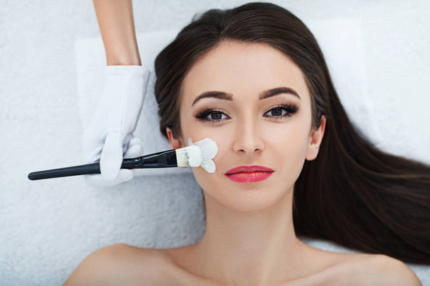Facial Skin Care. Beautiful Woman Getting Cosmetic Mask In Salon - Photo, Image