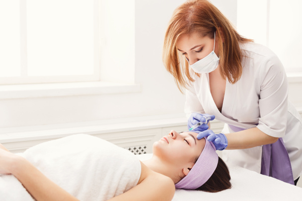 Woman getting beauty injection at salon - Photo, Image