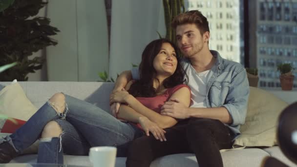 4K Affectionate young couple relaxing on couch in city apartment - Felvétel, videó