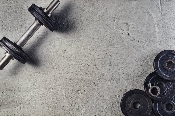 Fitness or bodybuilding background. Dumbbells on gym floor, top view - Foto, imagen