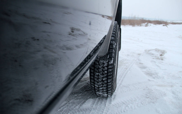 Snow traces of tread blocks by winter tires under off road vehicle outdoor  - Photo, Image