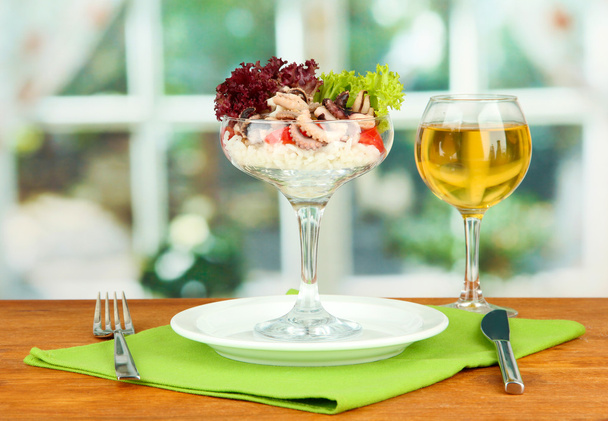 Delicatessen seafood salad with rice in glass on bright background - Foto, imagen