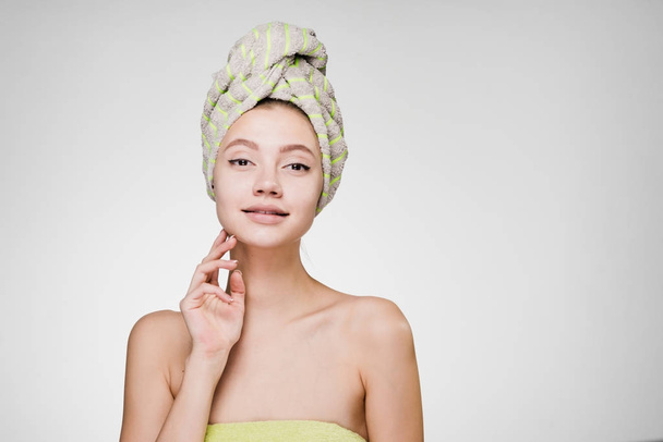 young attractive girl with a towel on her head enjoying a spa - Фото, зображення