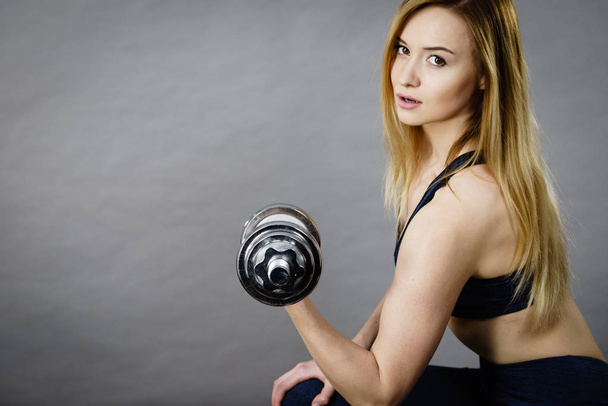 Woman working out at home with dumbbell - Fotó, kép