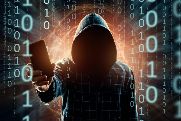 A young hacker in a hood hacks a smartphone, a hacker attack, a silhouette of a man, mixed media. The concept of a sudden attack, cryptography, data security, mobile Internet. - Foto, Bild