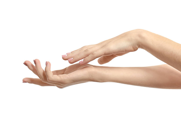 Hands of young woman with healthy skin softened by cream with moisturizing effect, on white background - Foto, afbeelding