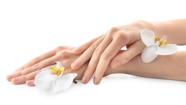 Young woman touching her hand and feeling moisturizing effect of cream on white background - Photo, Image