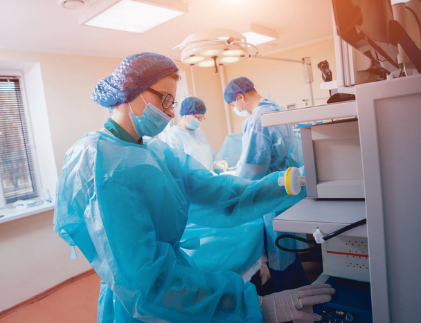 Group of surgeons in operating room with surgery equipment. - Φωτογραφία, εικόνα
