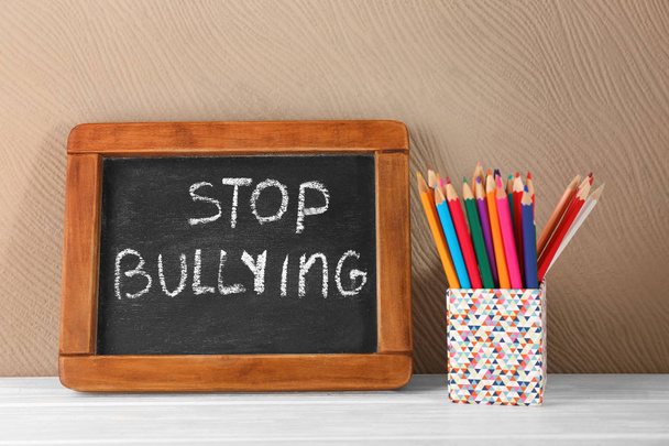 Chalkboard with text "Stop bullying" on table - Фото, изображение
