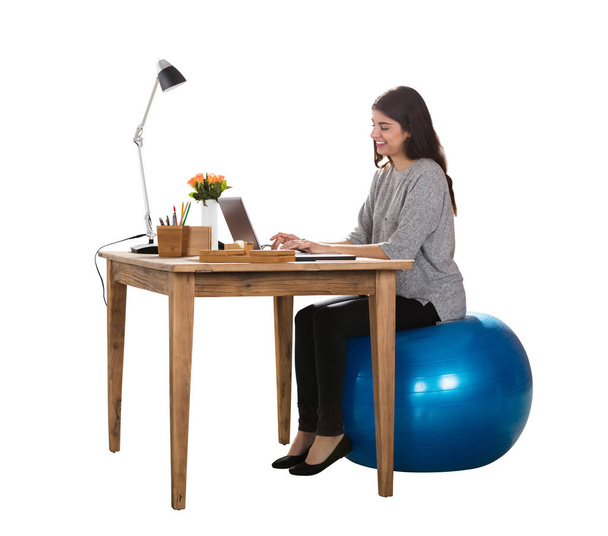 Happy Young Woman Sitting On Pilate Ball Working On Laptop - Fotoğraf, Görsel