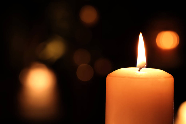 Burning candle in darkness   - Photo, image