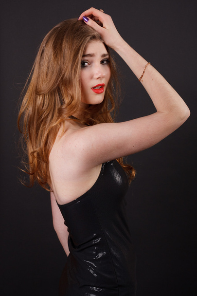 Pretty young woman in a black dress. - Foto, afbeelding