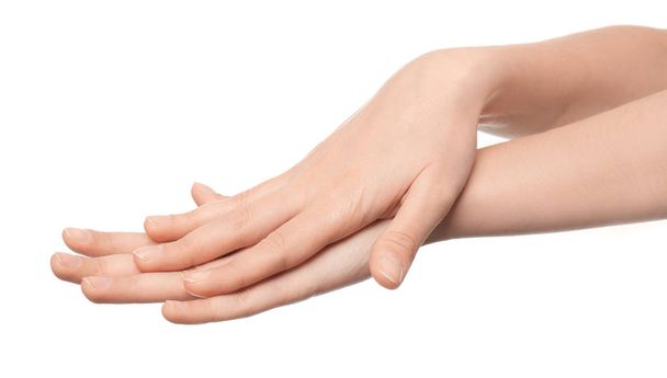 Hands of young woman with healthy skin softened by cream with moisturizing effect, on white background - Photo, image