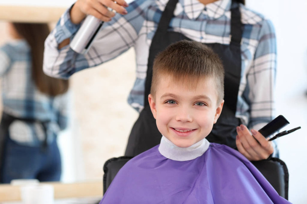 hairdresser working with little boy - Фото, изображение