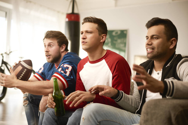 Unhappy men while watching american football - Foto, afbeelding