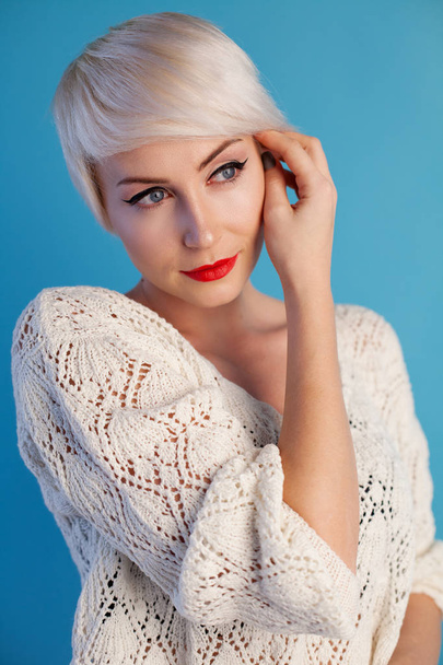 Portrait of blonde with short hair on a blue background - Foto, Bild