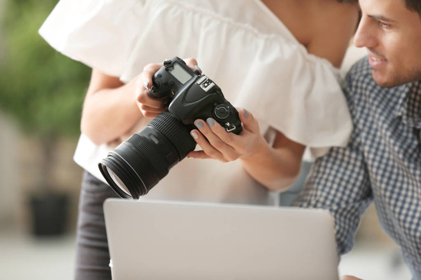 Young photographers with camera in office - Foto, Imagem