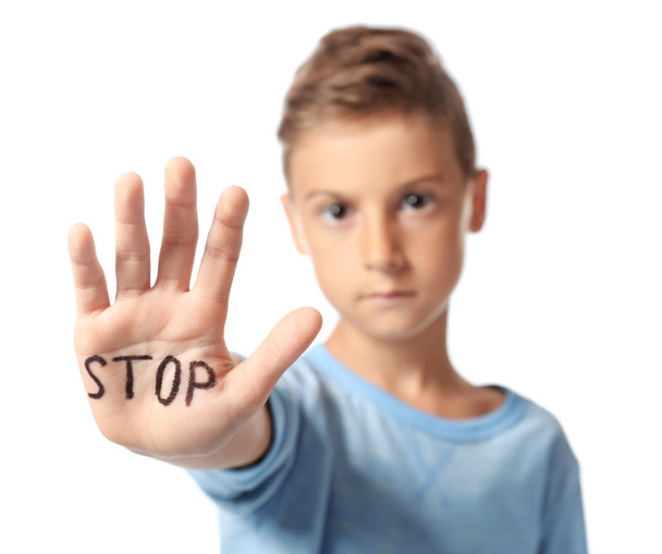 Little boy with word "Stop" on his hand against white background - Foto, afbeelding