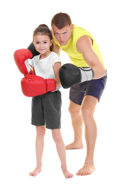 Cute little girl with boxing coach on white background - Foto, Bild