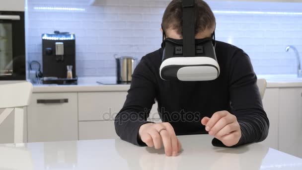 Man Wearing VR Headset at kitchen. Using Gestures with Hands. - Felvétel, videó