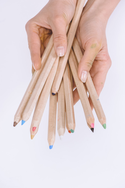 vista parziale di mani femminili che tengono pastelli colorati isolati su bianco
  - Foto, immagini