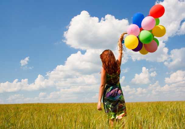 Happy young woman and colorful balloons - Фото, изображение