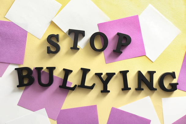 Text "Stop bullying" on table, top view - Foto, Bild