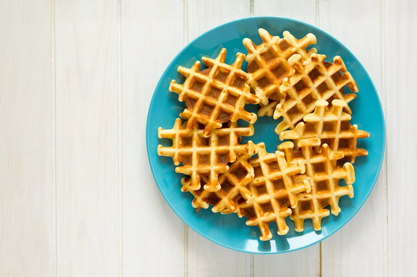 Homemade Belgian waffles on blue plate. Selective focus - Photo, image