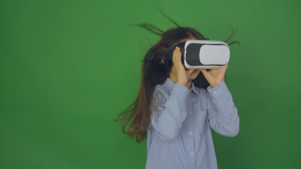 High quality video of child wearing virtual reality glasses. Happy girl loocing in virtual reality glasses, slow motion, camera in 4K. - Footage, Video