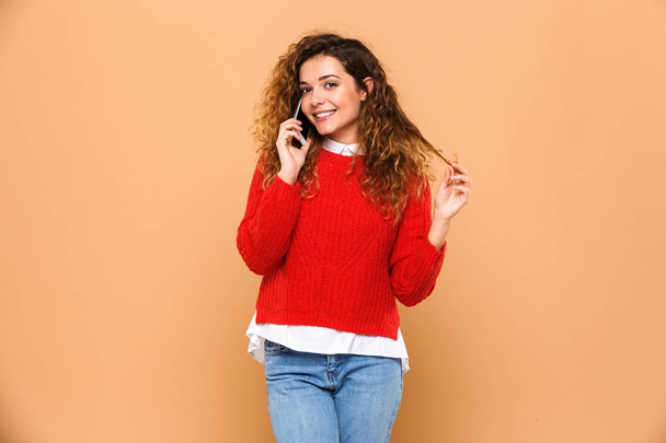 Portrait of a lovely smiling girl talking on mobile phone - Photo, image